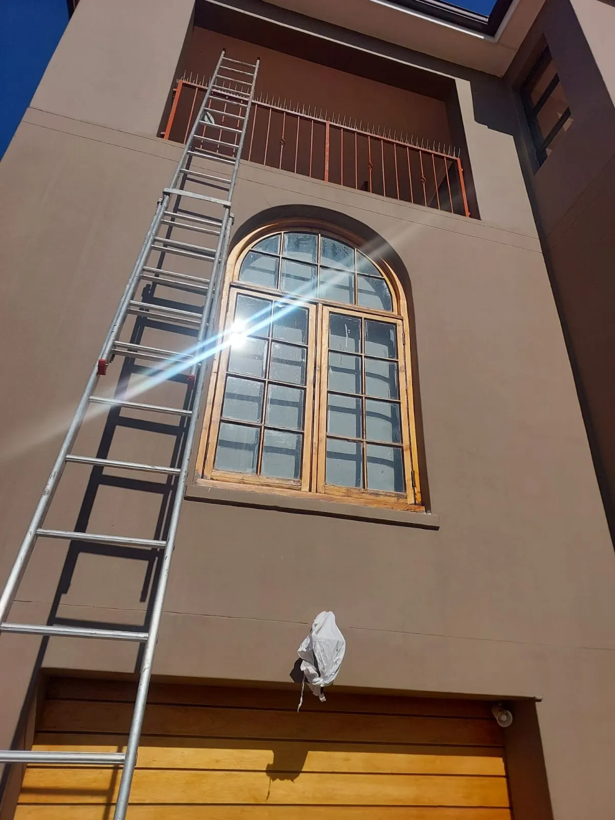 Double storey home freshly painted in a warm brown exterior finish