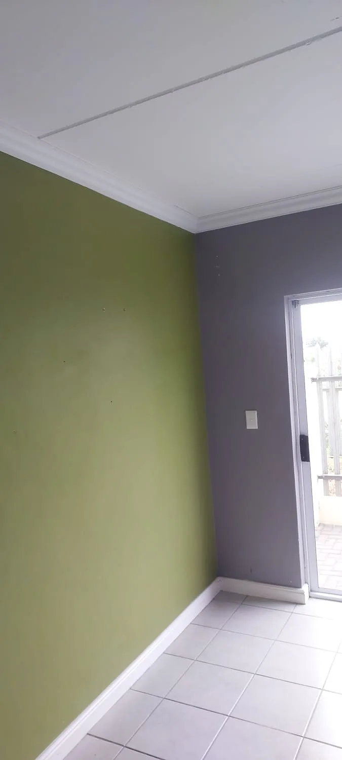 Olive green feature wall with grey interior paint