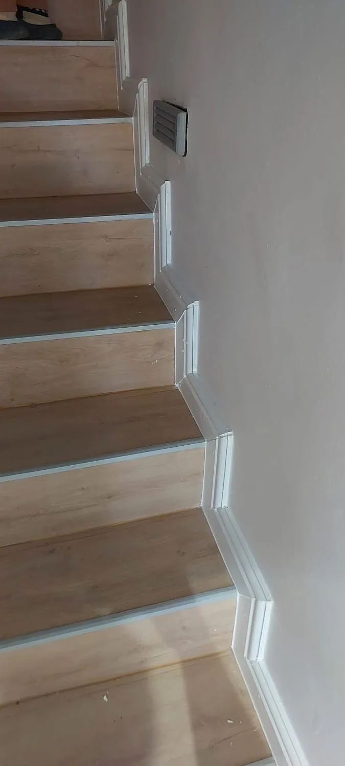 Stairwell wall painting alongside timber-look stair treads