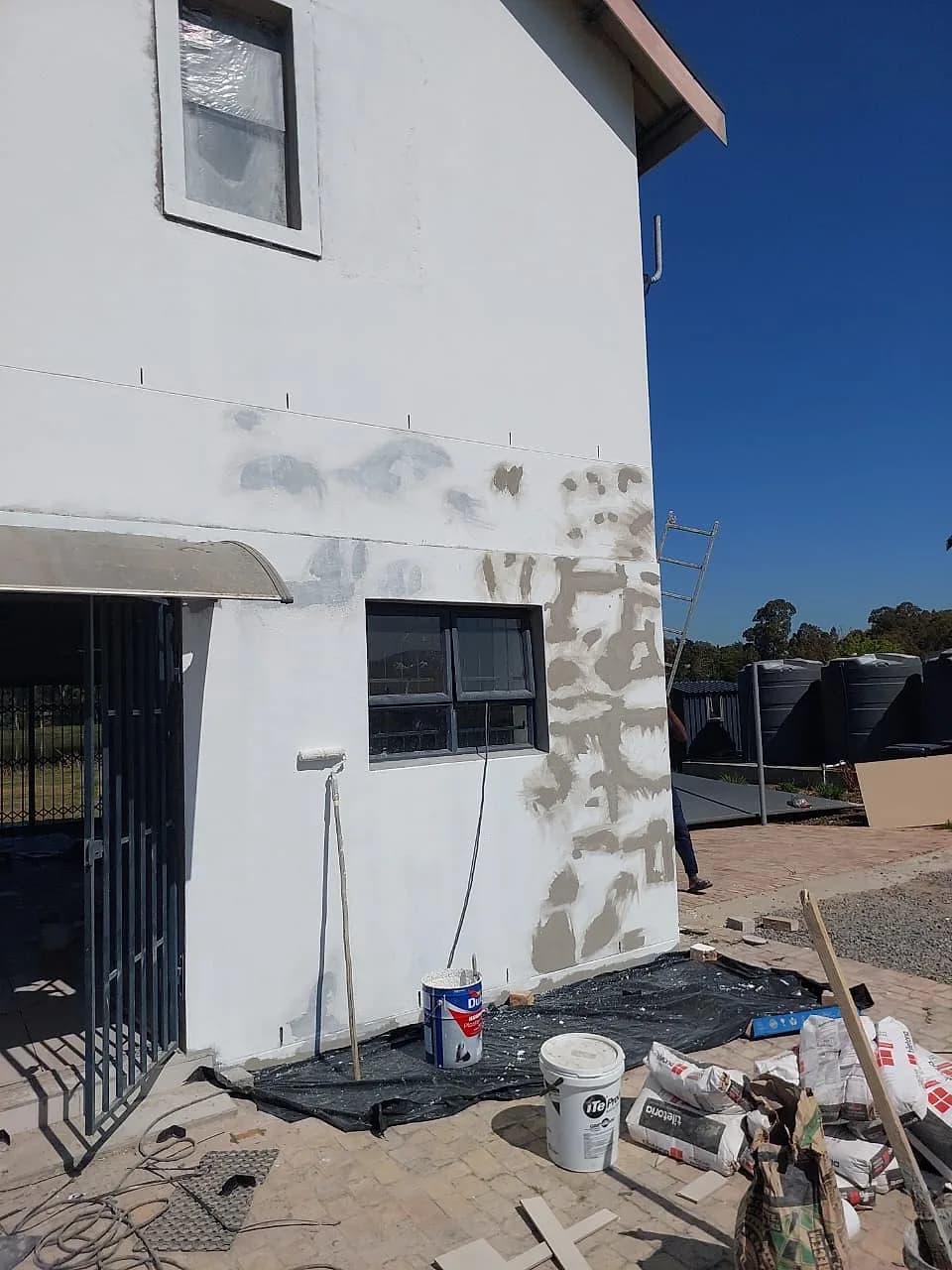Plaster crack repairs and preparation before an exterior repaint