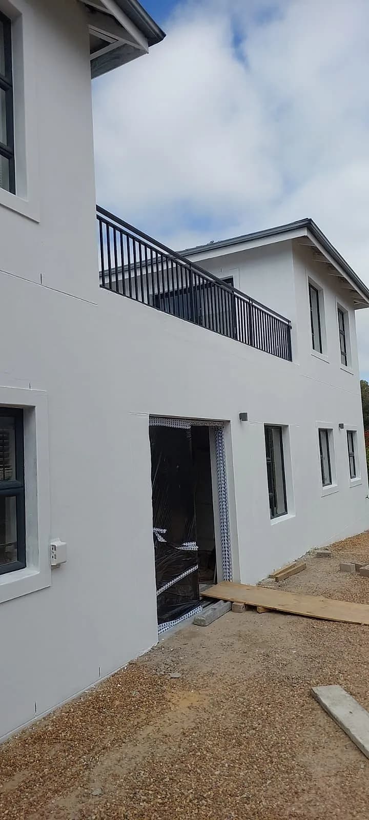 White exterior painting with black steel balcony balustrades